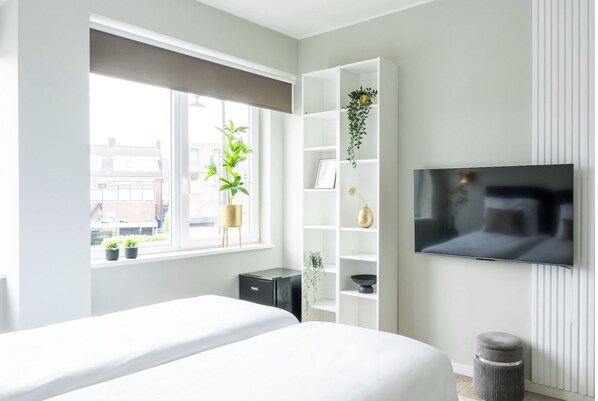 A bright and airy room fitted with smart conveniences for a modern stay.
