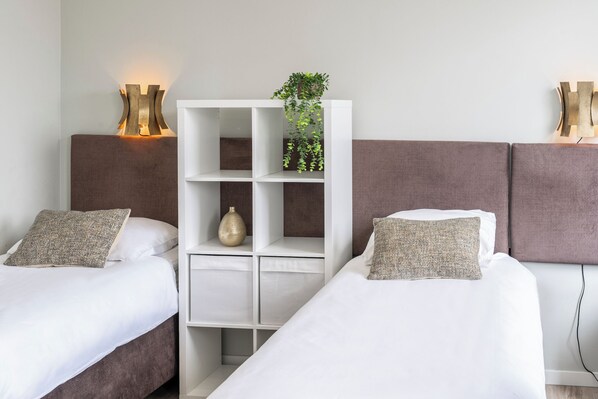 Cozy twin beds with plush headboards and soft linens, offering flexibility for guests. These beds can be arranged separately or easily combined to create a comfortable double bed, catering to your specific needs. Perfect for both individual travelers and couples seeking a tailored sleeping arrangement.