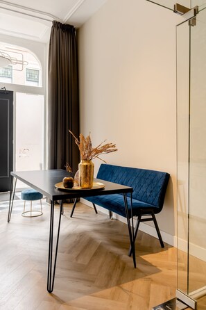A stylish dining area with a modern blue bench and minimalist decor, creating a cozy and inviting atmosphere.