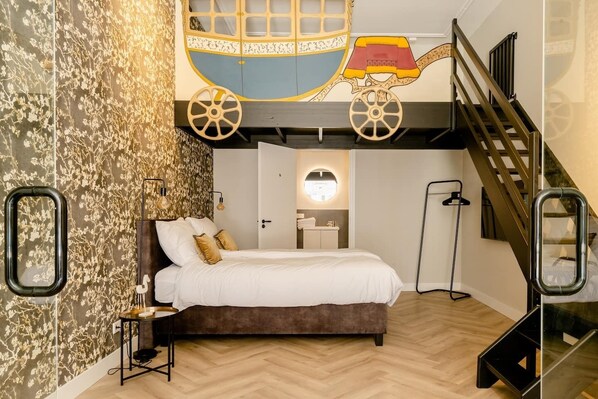 A unique bedroom design featuring a playful, colorful mural and a lofted bed, creating a whimsical and cozy atmosphere.