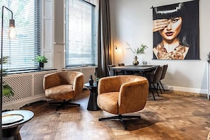 Stylish and cozy living area with unique artwork and comfortable seating, perfect for relaxing or socializing.