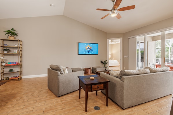 Cozy Living - - Relax in this inviting space with comfortable seating and a smart TV
- Open layout connects the living room to the outdoor patio, perfect for easy flow
- Large windows and a ceiling fan, this space feels fresh & breezy, ideal for unwinding