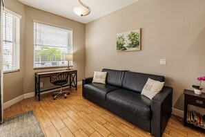 Quiet Workspace - - Bright corner with a plush sofa & desk, perfect for a quiet work or study session
- Large windows allow natural light to fill the space, keeping you energized and focused
- Simple, inviting decor makes it an ideal spot for relaxation or creativity