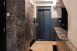 Sleek and modern elevator area with elegant marble accents, designed for a smooth and stylish experience.