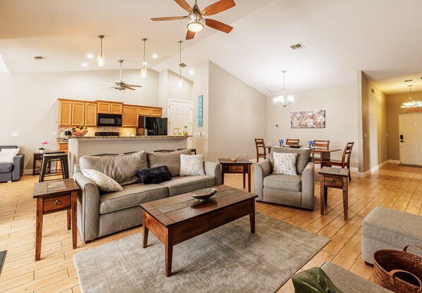 Spacious Retreat - - Relax in this bright, spacious living area with warm wood tones and cozy seating
- The open-concept layout creates a welcoming space for gatherings and family time
- Perfect for movie nights, game days, or unwinding with a good book