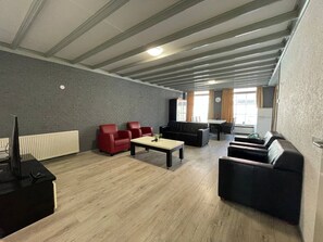 Take a seat and enjoy the spaciousness of the area, with large windows framing views of the outdoors.
