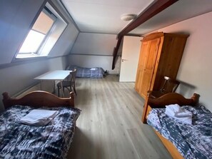 A cozy, rustic bedroom featuring warm wood furnishings and soft lighting, creating a serene and inviting ambiance.