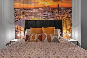 Snuggle up in this inviting bedroom, featuring a cozy bed that promises restful nights and sweet dreams.