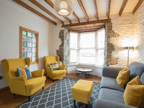 Table under the window, armchairs and sofa