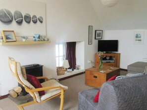 Living area with sofa, armchair, tv