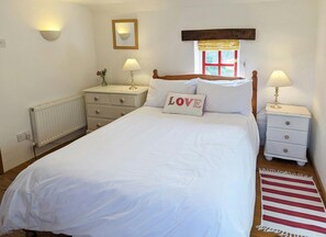 Bedroom with bed, bedside drawers and lamps