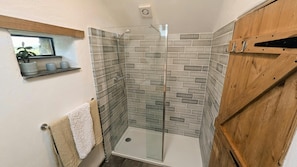 Shower room with walk in shower, towel rail, small high window