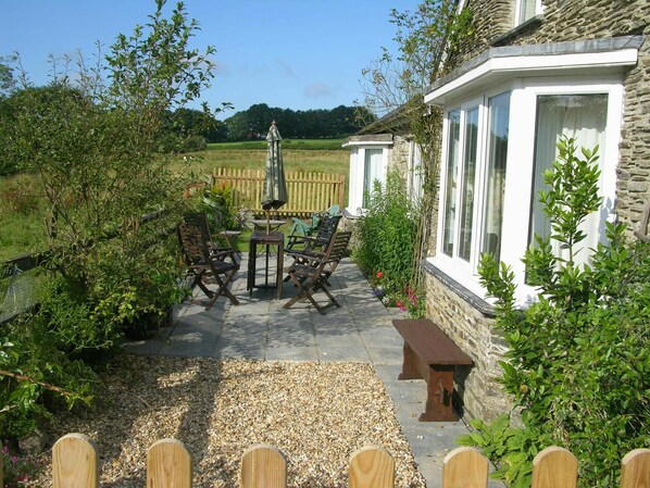 Furnished patio area with countryside views at Glanyrafon Smithy