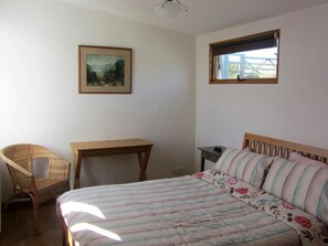 One of the double bedrooms with bed, bedside table, chair