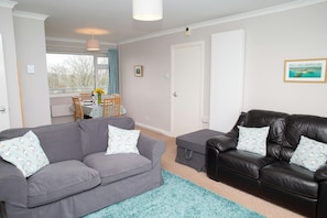 Lounge with 2 two seater sofas and sea views