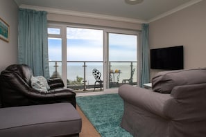 Lounge with patio doors leading to the balcony