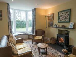 Lounge with fireplace and woodburner, bay window, sofa