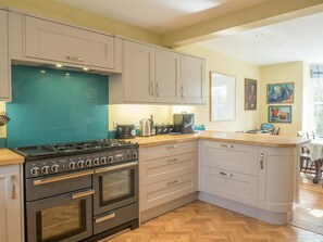 Kitchen with cooker, view of dining area