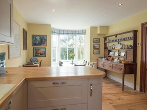 Kitchen and dining area with dresser and bay window