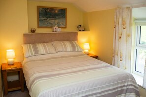 Double bed with bedside tables and lamps