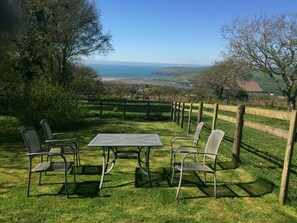 View from the garden, with sea views, outdoor table and chairs