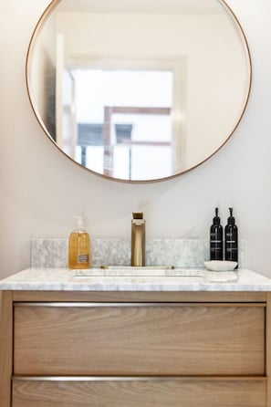 Indulge in the luxury of our walk-in rain shower, set in a tiled bathroom designed for relaxation. This stylish apartment, complete with high-end amenities, offers a serene escape in downtown Stratford’s lively atmosphere