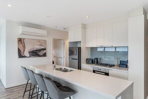 Kitchen area with breakfast bar. Fully equipped with all the amenities you would need for a comfortable stay. 