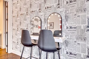 Experience a chic Nashville getaway in this stylish vanity area with fun newspaper wallpaper—perfect for getting ready with friends! Ideal for bachelorette parties or family reunions, enjoy luxury and great company in this upscale rental.