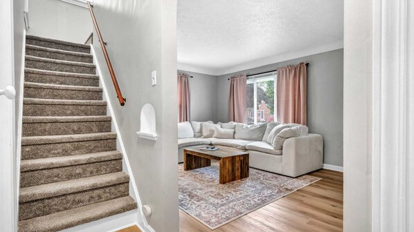 Calm ambience in the living room—soft lighting, cozy textures, neutral tones. A space that invites you to breathe, unwind, and just be. Peace lives here, one quiet moment at a time.