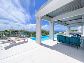 Deckchairs and shaded terrace with pergolas