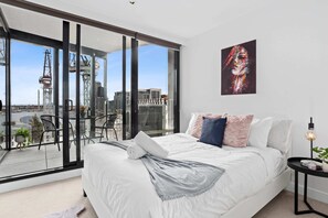 The master bedroom with a queen bed and plush pillows.