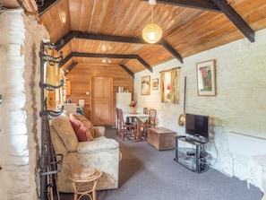 Living area with dining table and chairs, tv, sofa