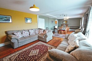 Sofas, armchair looking through to the dining table and chairs