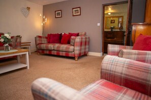 Sitting room with sofa, arm chairs and coffee table
