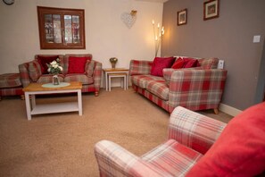 Sitting room with two sofas and arm chairs