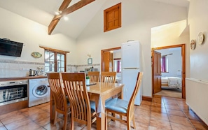 Kitchen with electric oven and hob and washing machine