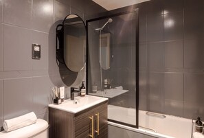 Well equipped bathroom, complete with a cozy bathtub and all the essentials.