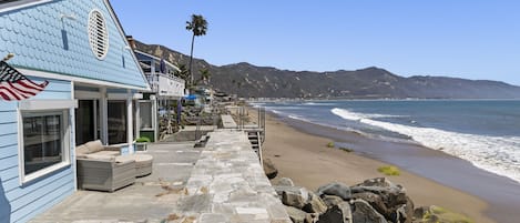 Ocean side - private patio, sea wall and private staircase direct to beach.