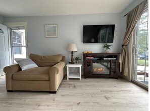 Living room with electric fireplace for heat and/or ambiance and smart TV