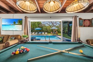 Challenge your friends to a game of pool or test your aim at the dartboard. Relax in front of the large smart streaming TV, surrounded by ample seating, with direct access to the pool deck.