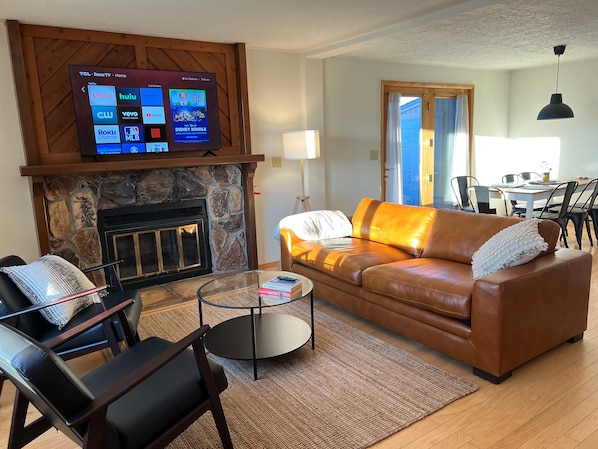 Relax with family and friends in the spacious living room w/ electric fireplace