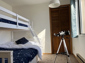 The bunk bed features a full mattress on the bottom and a twin on top