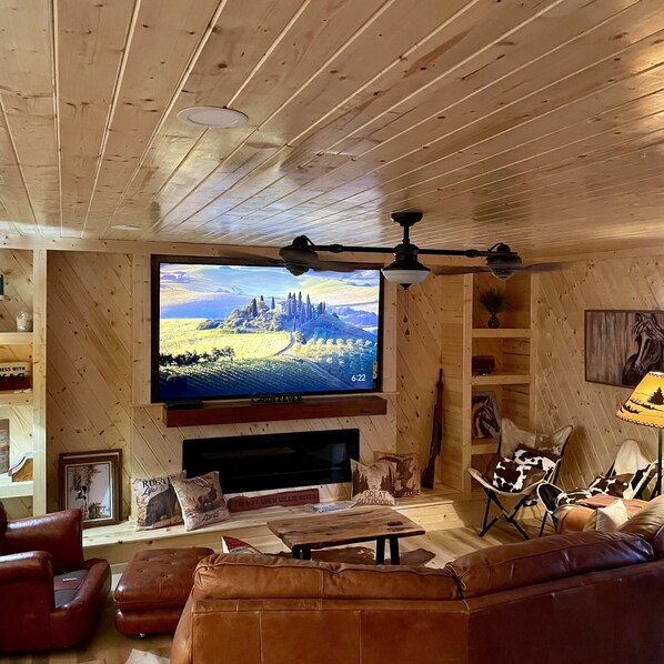 Open living w 85" TV.