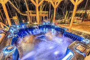 Elegant outdoor 1st of the 2 hot tubs for serene, starlit relaxation.