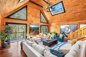 The primary living room blends the charm of a log home with modern aesthetics.