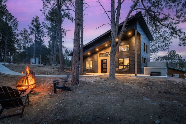 Escape to serenity at our pond-side cabin complete with a cozy hot tub and inviting fire pit for the ultimate relaxation retreat