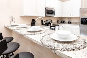 Sip morning coffee or grab a bite at the kitchen counter, with seating for 4