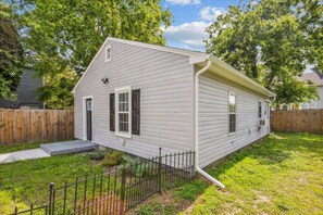 The exterior of this cute little bungalow! A privacy fence for your pets around the back, please keep in mind the larger part of the yard is for the front house guests.