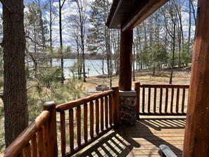 View of the yard and lake walking along the deck on the side of the house.