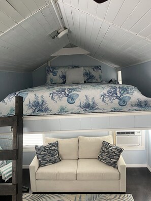 Queen size bed in loft.